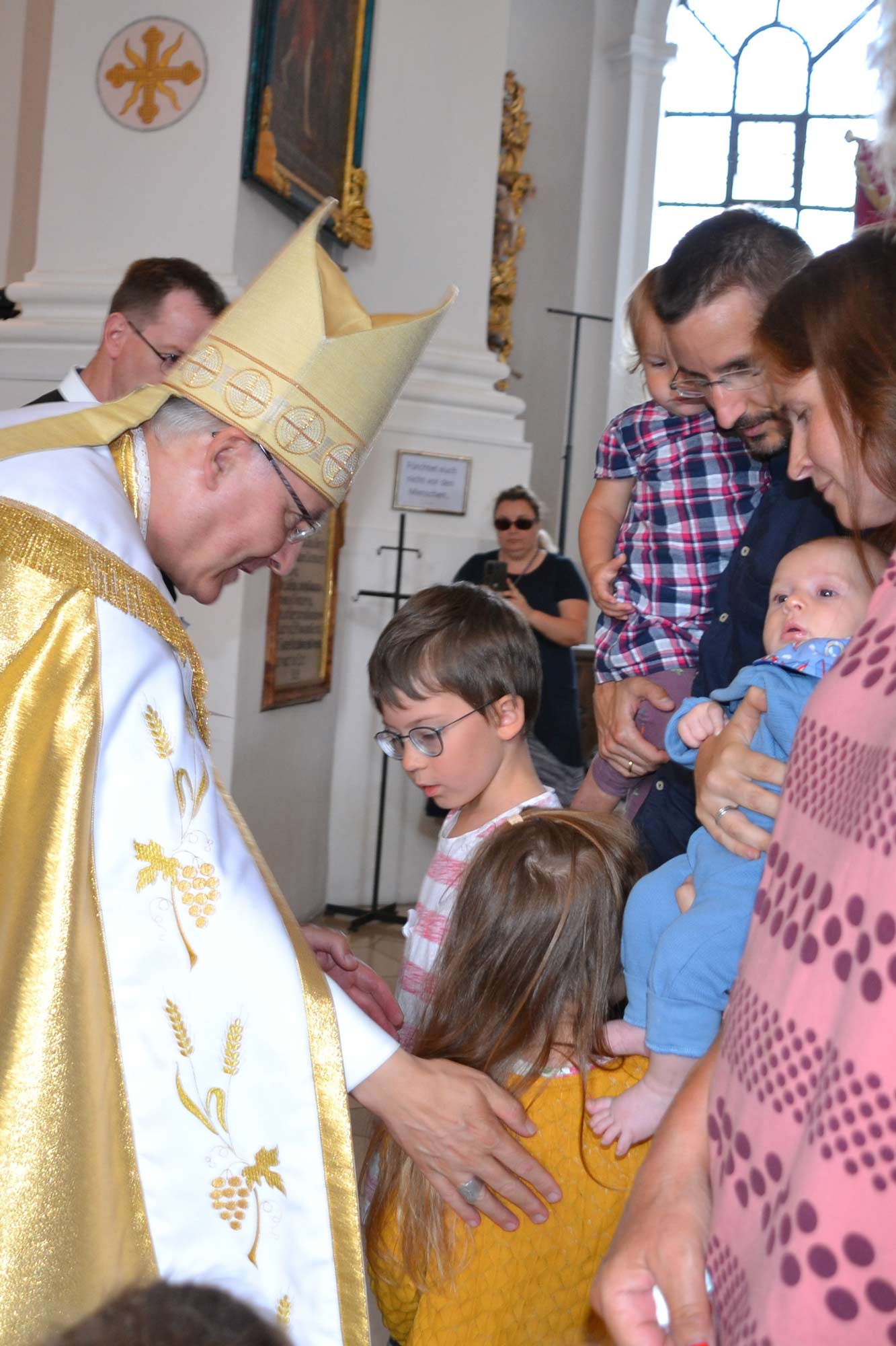 Bischof segnet ein Kind