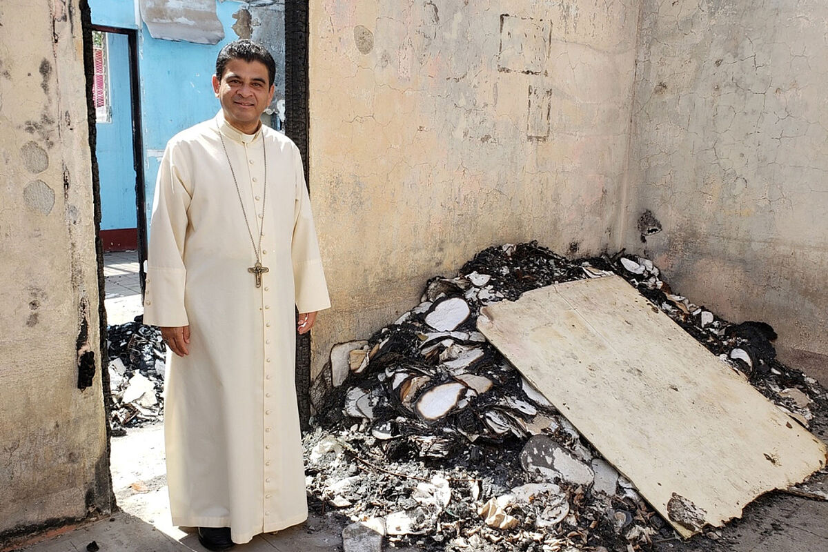 Priester im Zimmer eines zerstörten Hauses