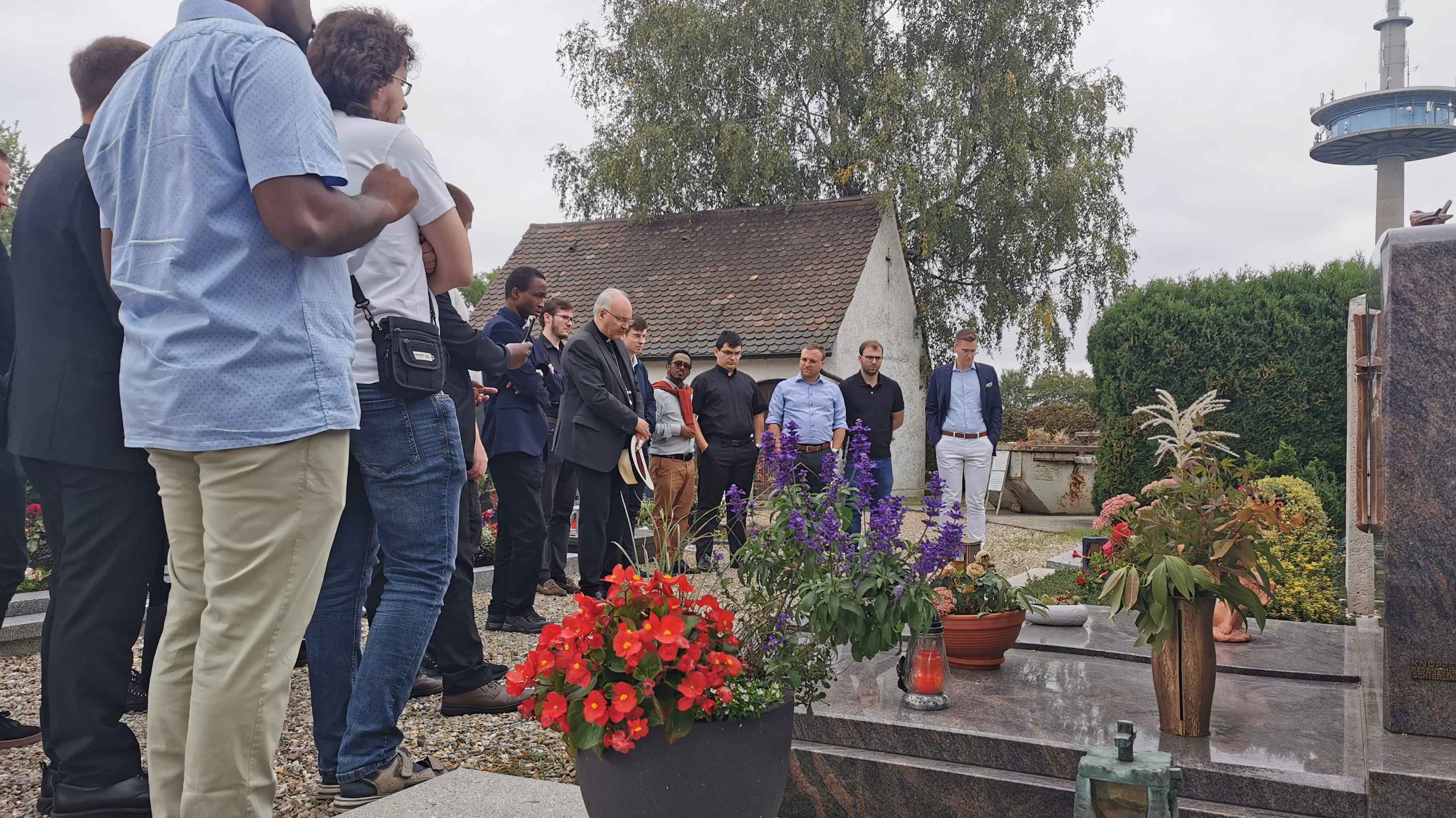 Seminaristen sprechen mit Bischof Rudolf ein Gebet am Grab der Eltern Ratzingers