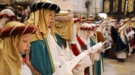 Sternsinger in einer Kirche beim Singen