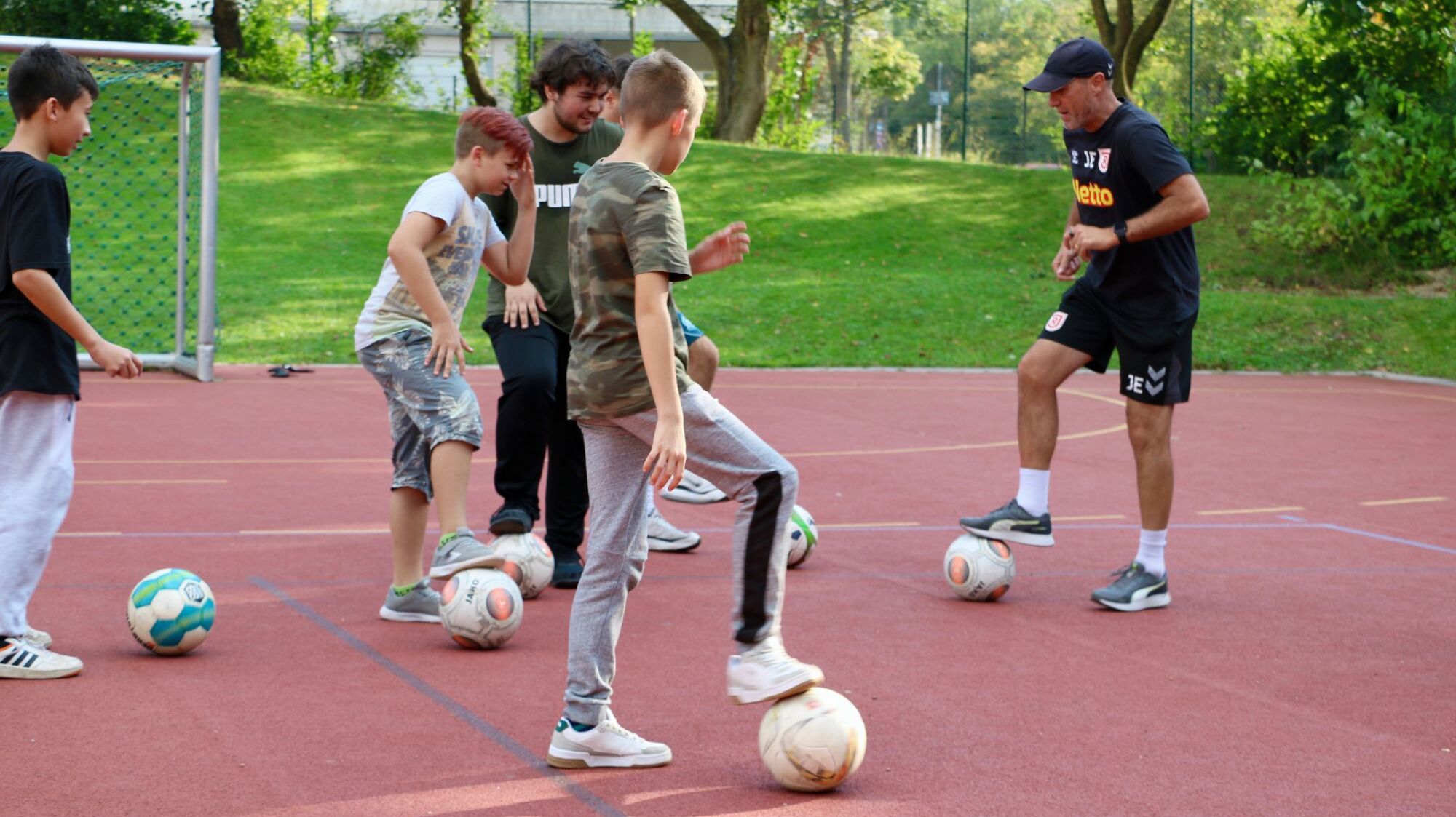 Trainer des SSV Jahn Joe Enochs begeistert Kinder in St. Vincent